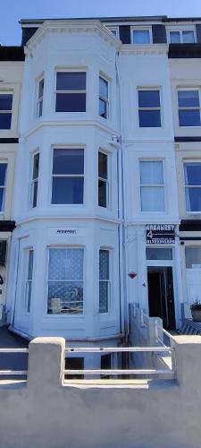 a white apartment building with a large window at Areawest in Scarborough