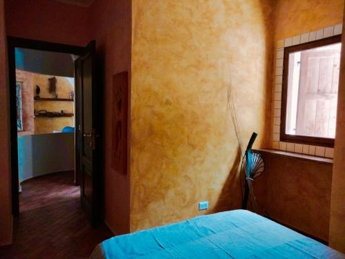 a bedroom with a bed and a window at Casa Rustica in Dorgali