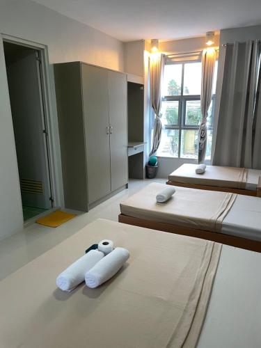 two beds in a bedroom with towels on the floor at Your Choice Hotel in Catbalogan