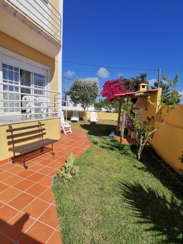 a bench sitting on the side of a house at Windmill Ericeira in Ericeira