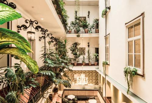 a room with plants on the walls and a staircase at Palais Hotel Erzherzog Johann in Graz