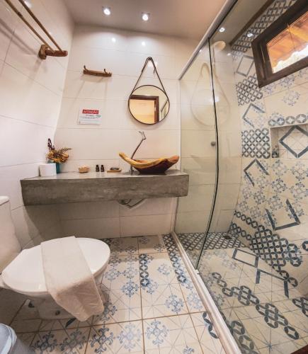 a bathroom with a toilet and a shower at Chalés das Margaridas in Vale do Capao