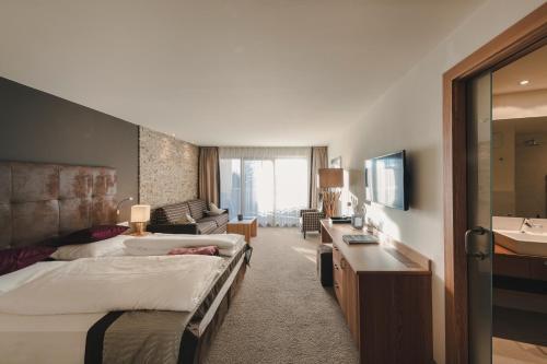 a hotel room with two beds and a sink at Hotel Viertler in Avelengo
