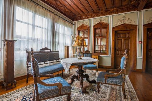 a living room with a table and chairs and a window at Old Legends Hotel in Plovdiv