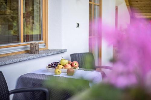 a table with a bowl of fruit on it at Oberplunerhof - Fewo Gitschberg in Chienes