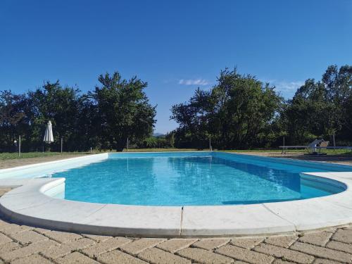 a large swimming pool with blue water at Tenuta San Giorgio in Serravalle Scrivia