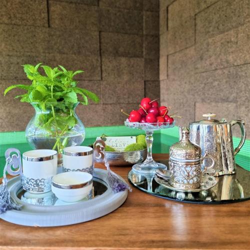 a table with a tray of tea cups and a plate of food at Douro Suites in Riba Douro