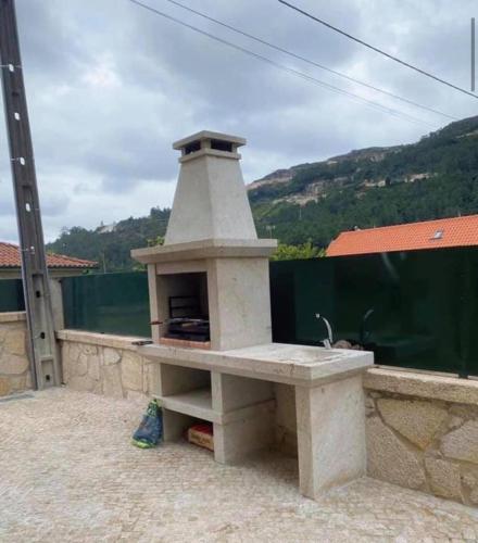 a stone oven sitting on top of a patio at Casa da presa in Ponte de Lima