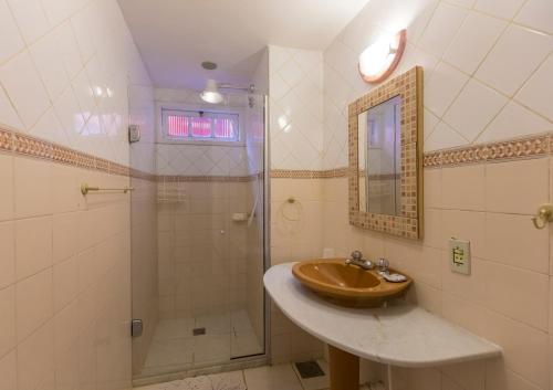 a bathroom with a sink and a shower at Pousada Chez Nice in Búzios