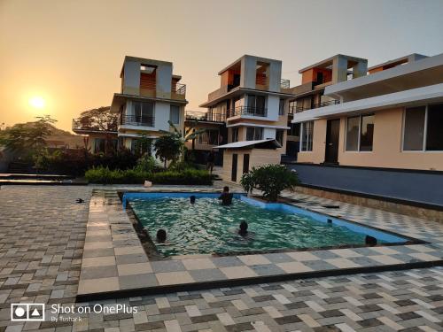 a swimming pool in front of a building at ROYAL MEADOWS IGATPURI VILLA D in Igatpuri