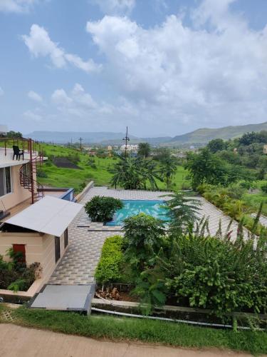 an aerial view of a house with a swimming pool at ROYAL MEADOWS IGATPURI VILLA D in Igatpuri