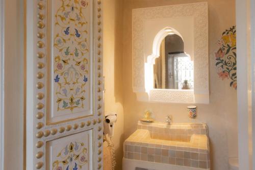 a bathroom with a sink and a mirror at Riad Palais Des Princesses & Spa in Marrakesh