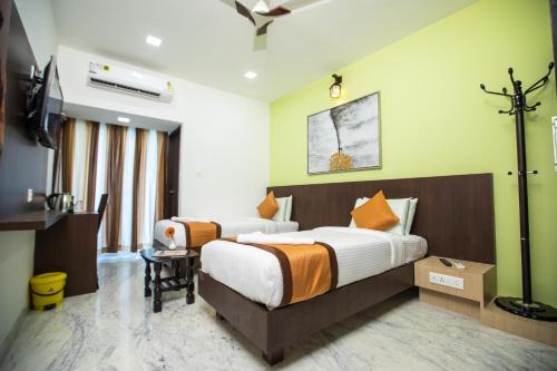 Ένα ή περισσότερα κρεβάτια σε δωμάτιο στο Grand Padappai Residency - GPR