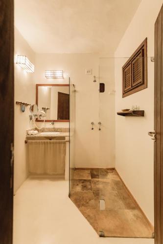 a bathroom with a shower and a sink at Casa na Praia in Jericoacoara