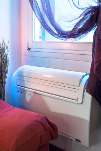 a window in a bedroom with a bed next to it at PICCOLO - Cozy studio in the heart of authentic Venice in Venice