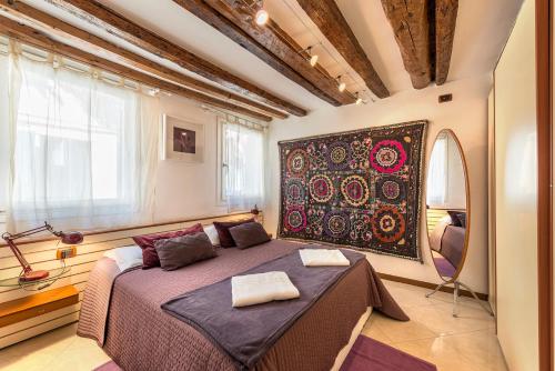 a bedroom with a large bed in a room at PICCOLO - Cozy studio in the heart of authentic Venice in Venice