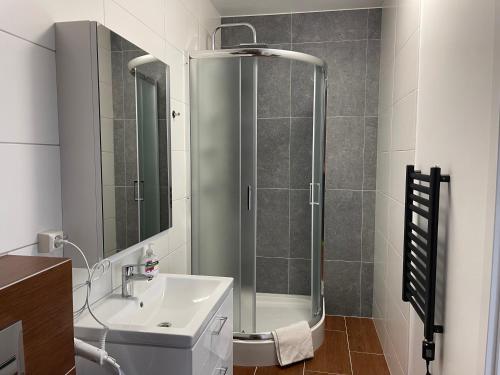 
a bathroom with a shower, sink, and toilet at Helgrindur Guesthouse in Grundarfjordur
