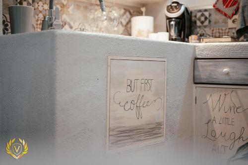 a kitchen counter with some writing on the wall at VenuSuite VENOSA - Luxury House, Spa & Relax - in Venosa