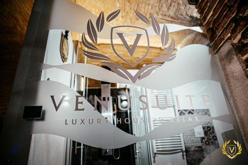 a sign for a luxury house with a logo at VenuSuite VENOSA - Luxury House, Spa & Relax - in Venosa