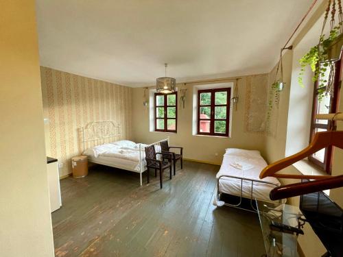 a room with a bed and a table and chairs at HARABURDI® Recyclart Hotel in Kostelec nad Orlicí