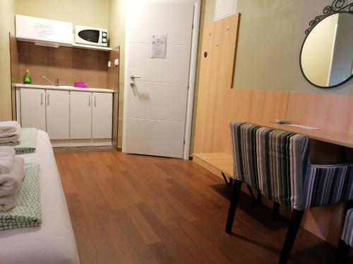 a small room with a kitchen and a white door at Studio Villa Antunovac in Zagreb