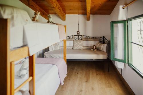 a small room with two beds and a window at La Caseta de Panisello in Deltebre