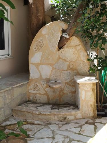 an outdoor stone oven in a house at Vacations in Patra Rooms in Patra