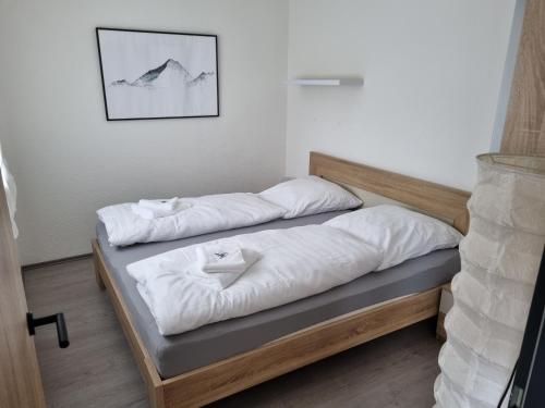 two beds with white pillows on them in a room at Ferienwohnung Schanzenblick in Winterberg