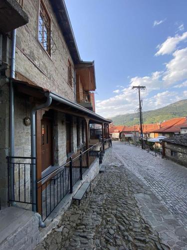 a cobblestone street next to an old building at 11 Luxury Apartments Metsovo in Metsovo