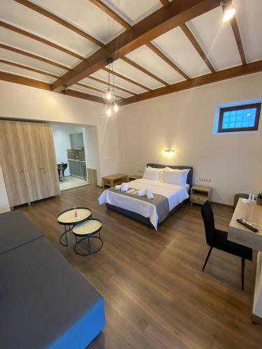 a bedroom with a bed and a living room at 11 Luxury Apartments Metsovo in Metsovo