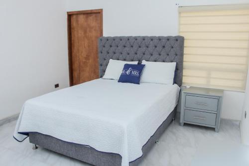 a bedroom with a bed with a blue pillow on it at VILLA COSTA FELIX 1 in Puerto Peñasco