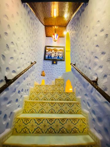a set of stairs in a building with a stair case at Casa El Mrabet in Chefchaouene