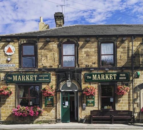 an old brick building with a market sign on it at Market in Elsecar