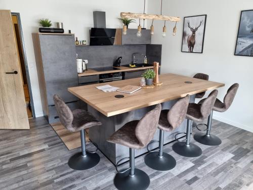 a kitchen with a wooden table and chairs at Ferienwohnung Schanzenblick in Winterberg