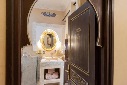 a bathroom with a sink and a mirror on the wall at Riad Palais Des Princesses & Spa in Marrakesh