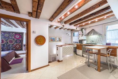 a kitchen with white walls and wooden ceilings at PICCOLO - Cozy studio in the heart of authentic Venice in Venice