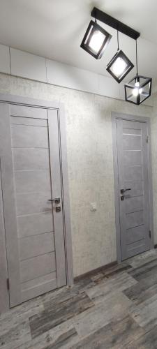 a room with a door and two lights on a wall at Victoria in Tiraspol