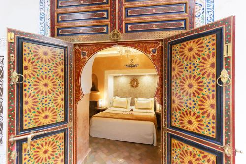 a bedroom with a bed and a dresser at Riad Palais Des Princesses & Spa in Marrakesh