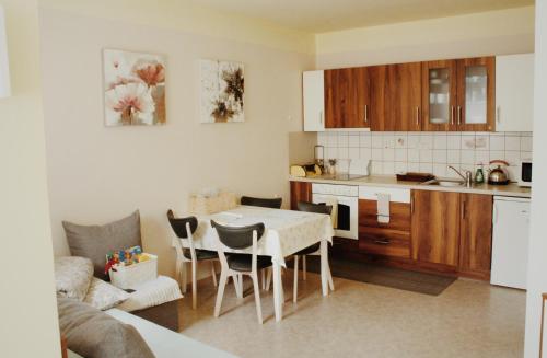 a kitchen and a dining room with a table and chairs at Apartmán "Pod Rokem" in Sušice