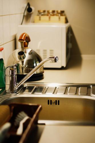 a kitchen counter with a sink and a toaster oven at Apartmán "Pod Rokem" in Sušice