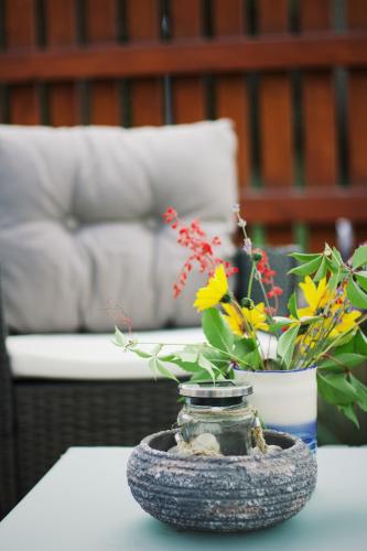 a glass jar with flowers in it on a table at Apartmán "Pod Rokem" in Sušice