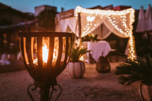 a lit lamp in front of a tent with lights at Casa na Praia in Jericoacoara