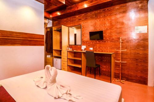 a room with a table with a towel on it at Summer Villa Guest House in Maafushi