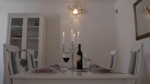 a dining room table with candles and wine glasses at Villa Claudia in Fažana