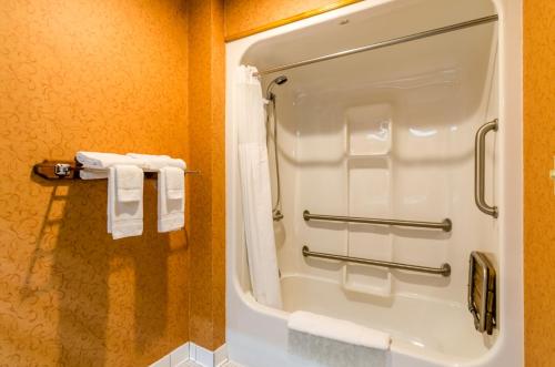 a bathroom with a shower with white towels at Quality Inn Eureka Springs South in Eureka Springs