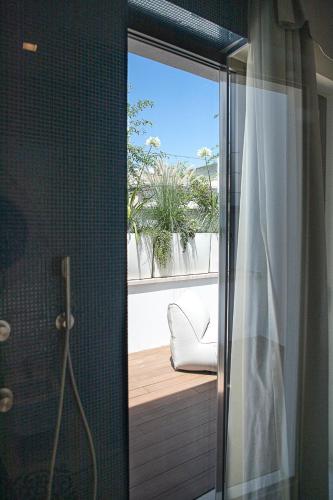 a bathroom with a shower with a view of a window at Ognissanti Restaurant Spa Hotel Rooftop in Trani