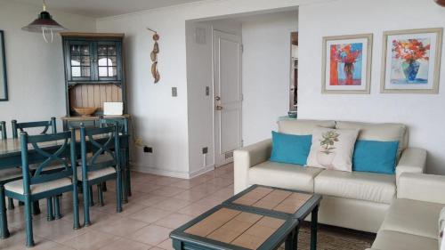 a living room with a couch and a table at Departamento Puerto Velero in Puerto Velero