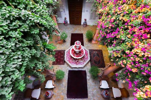 a table topped with flowers and umbrellas at Riad Palais Des Princesses & Spa in Marrakesh