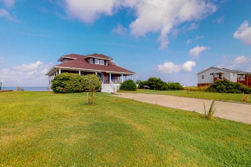 a house sitting on top of a lush green field at Reel Living #3-AV in Avon