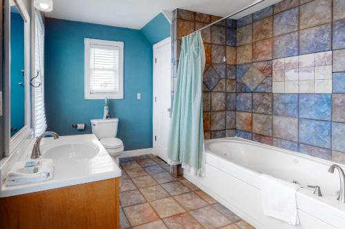a bathroom with a tub and a toilet at Reel Living #3-AV in Avon